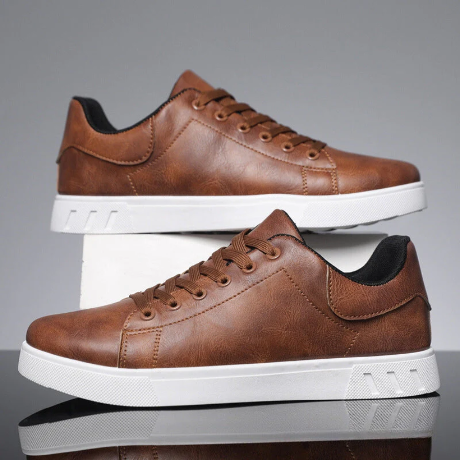 Men's brown faux leather lace-up sneakers with a sleek low-profile design and a thick white rubber sole.