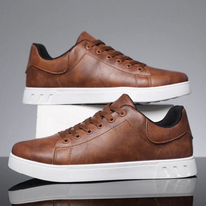 Men's brown faux leather lace-up sneakers with a sleek low-profile design and a thick white rubber sole.