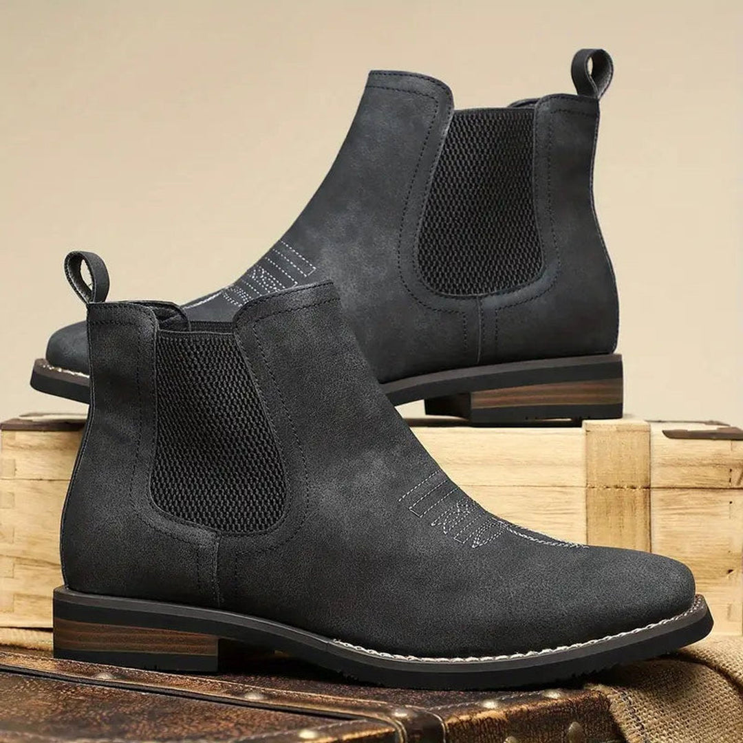 Men's charcoal faux leather western Chelsea boots with elastic side panels, pull tabs, and stacked block heels.