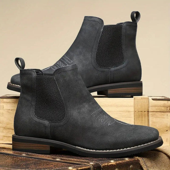 Men's charcoal faux leather western Chelsea boots with elastic side panels, pull tabs, and stacked block heels.