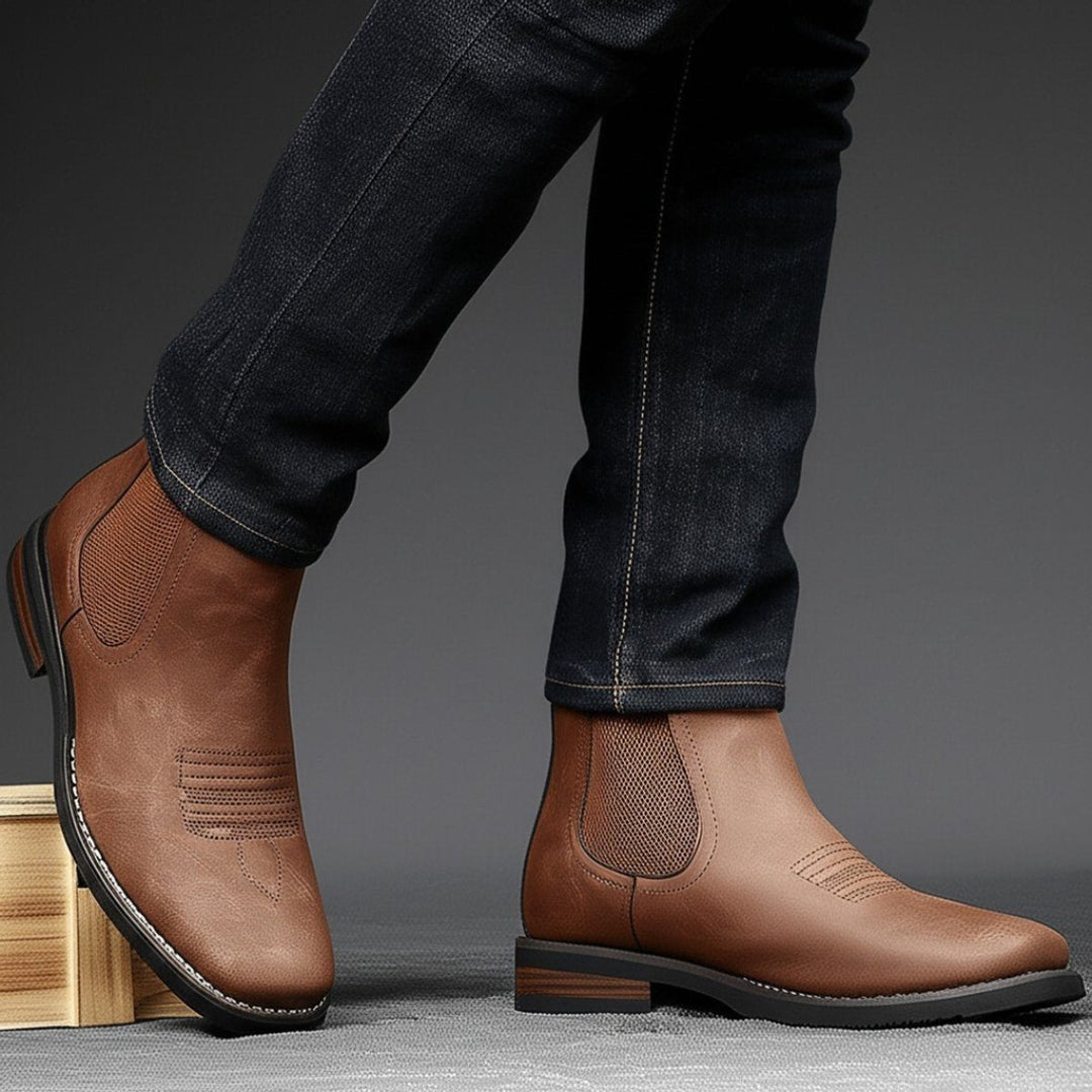 Men's brown distressed faux leather Western Chelsea boots with elastic side panels, toe stitching, and stacked block heels.