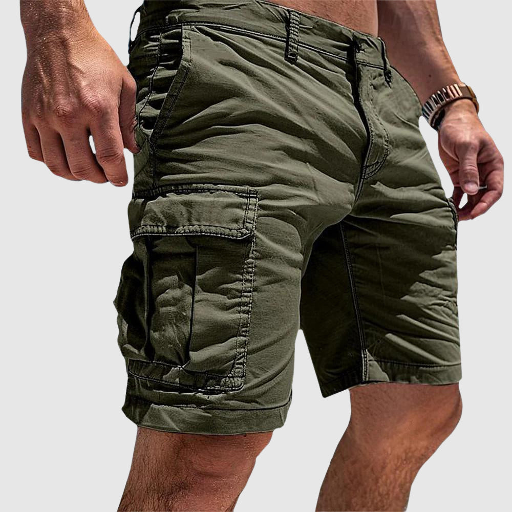 Olive green knee-length cargo shorts in soft washed cotton with large flap-top side pockets and a relaxed athletic fit.