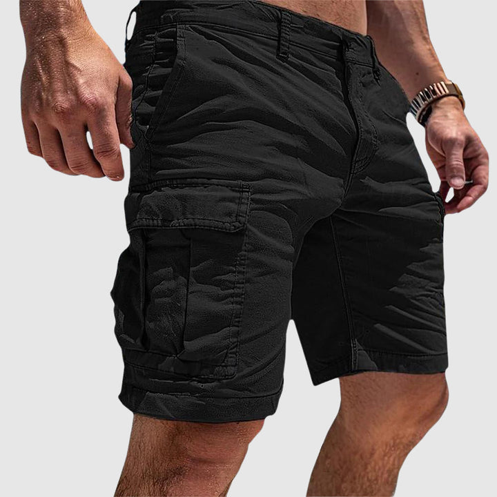 Black knee-length cargo shorts in soft washed cotton with side flap pockets and a relaxed athletic fit.