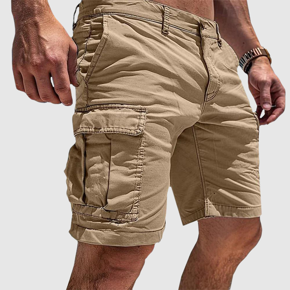 Men's tan knee-length cargo shorts in soft washed cotton with side flap pockets and a relaxed athletic fit.