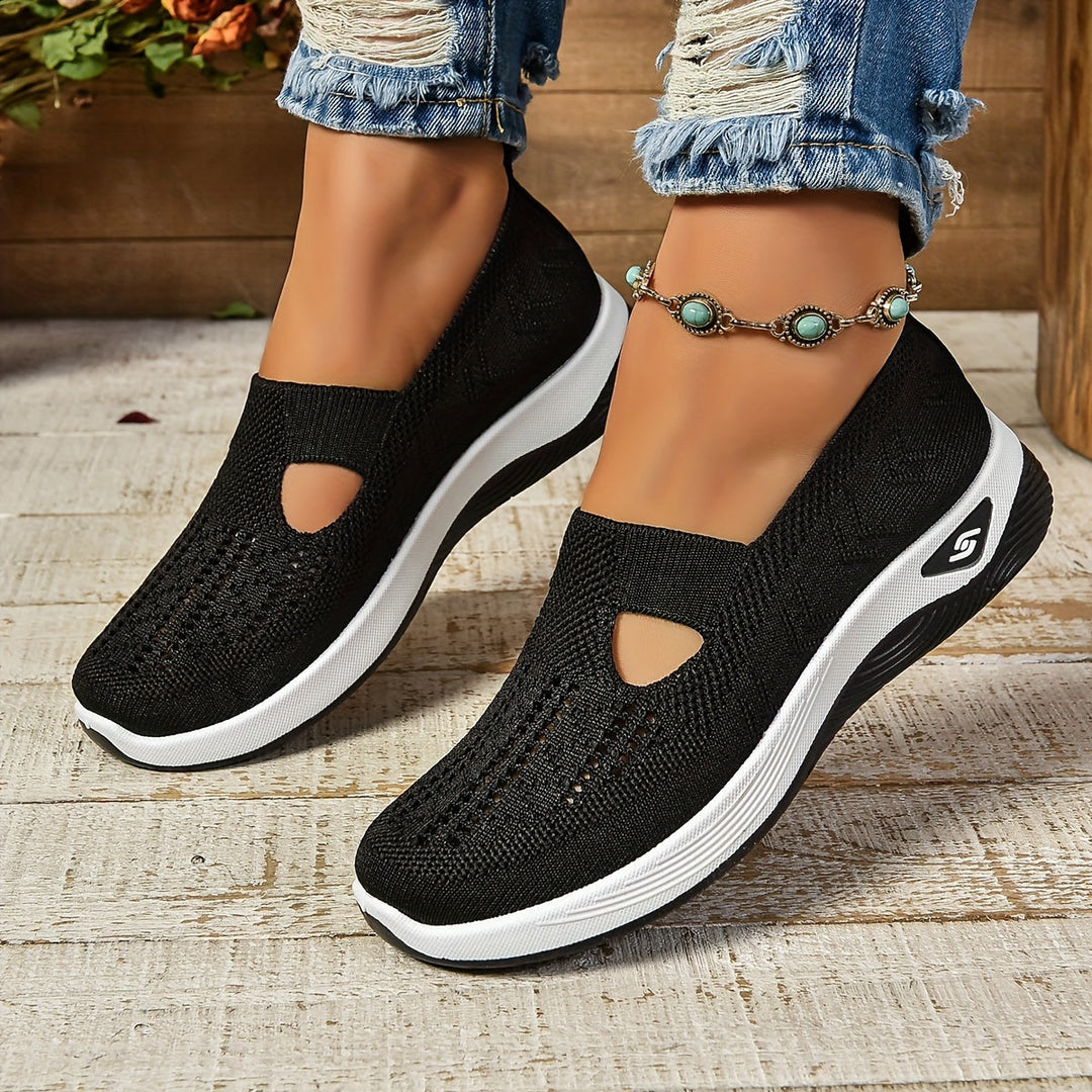 Black Lottie slip-on trainers featuring a breathable knit upper and a comfortable, cushioned white platform sole.