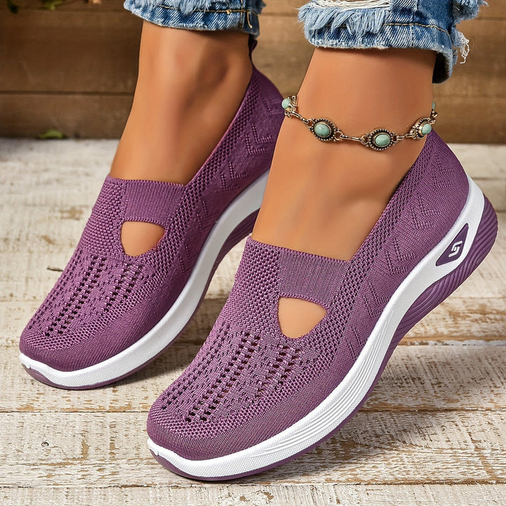 Purple slip-on knit trainers featuring a breathable mesh design and a comfortable, cushioned white platform sole.