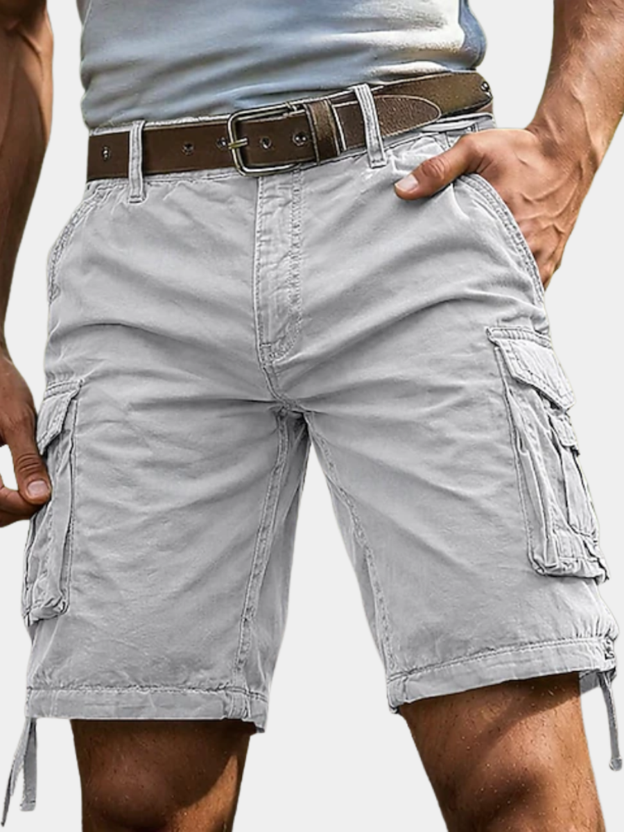 Light grey knee-length cargo shorts with multiple side pockets and a brown leather belt on a man.