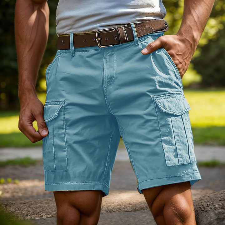 Light blue knee-length cargo shorts with side pockets and a brown leather belt, worn by a man outdoors.