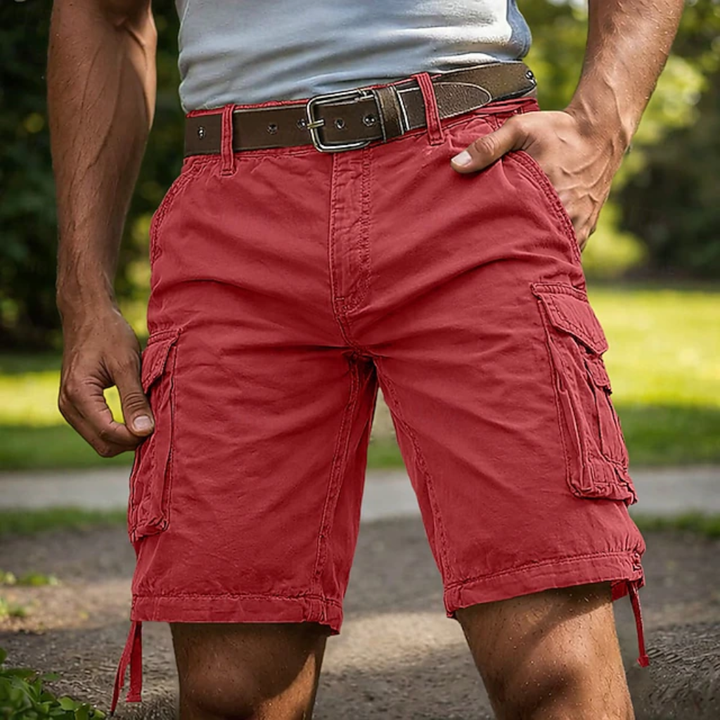 Red knee-length cargo shorts with side pockets and a brown leather belt worn outdoors.