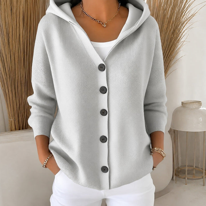 Soft grey knitted hooded cardigan featuring a relaxed fit and wooden-effect button-up front for cosy layering.