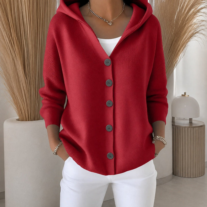 Soft red knitted hooded cardigan with a button-up front and relaxed fit, perfect for cozy, stylish layering.