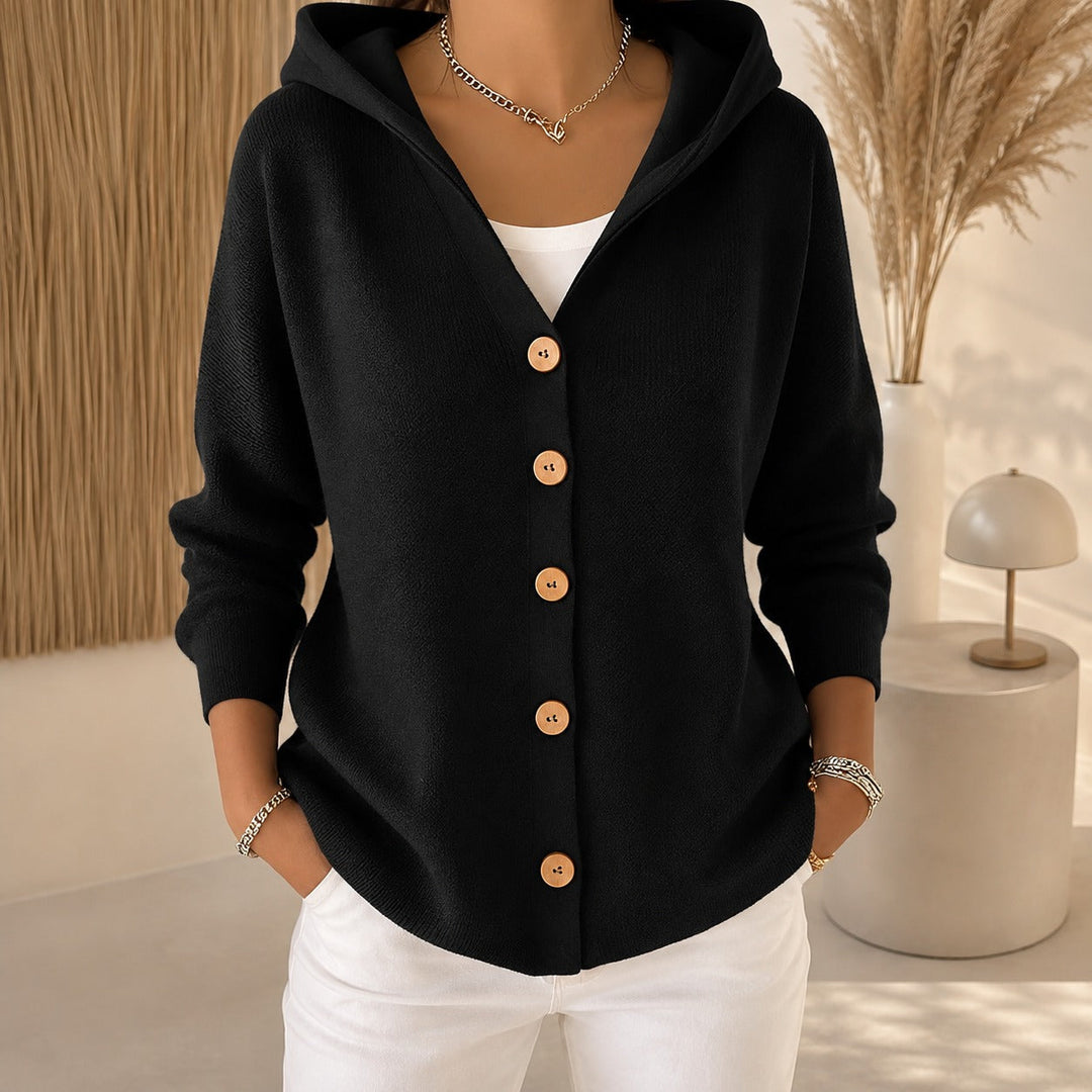 Black knitted hooded cardigan featuring a relaxed fit and stylish wooden-effect buttons for effortless layering.