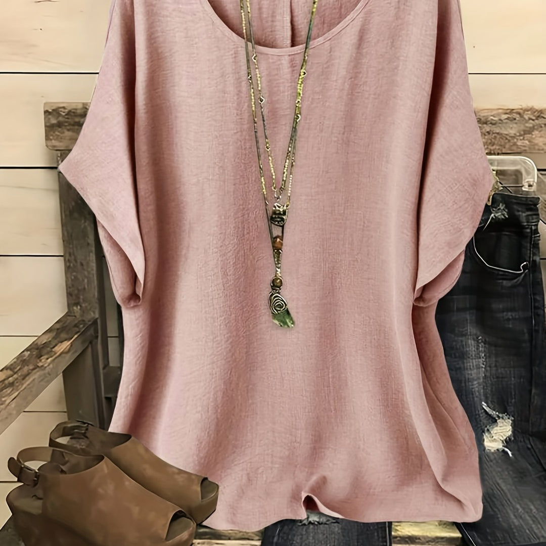 Dusty pink linen-look top with a round neck and relaxed batwing sleeves, styled with a layered pendant necklace.