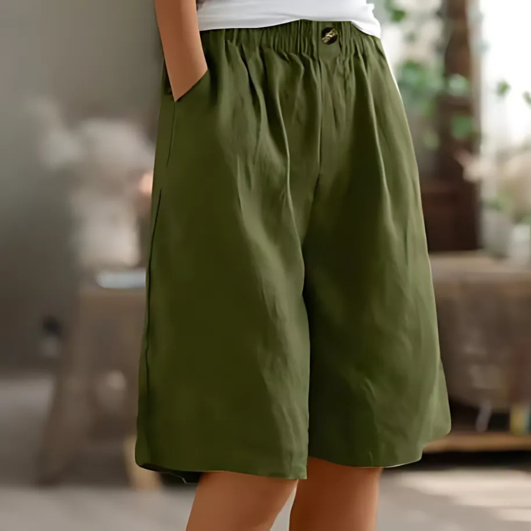 Maisie women's olive green elastic waist Bermuda shorts with pockets and a single button detail.