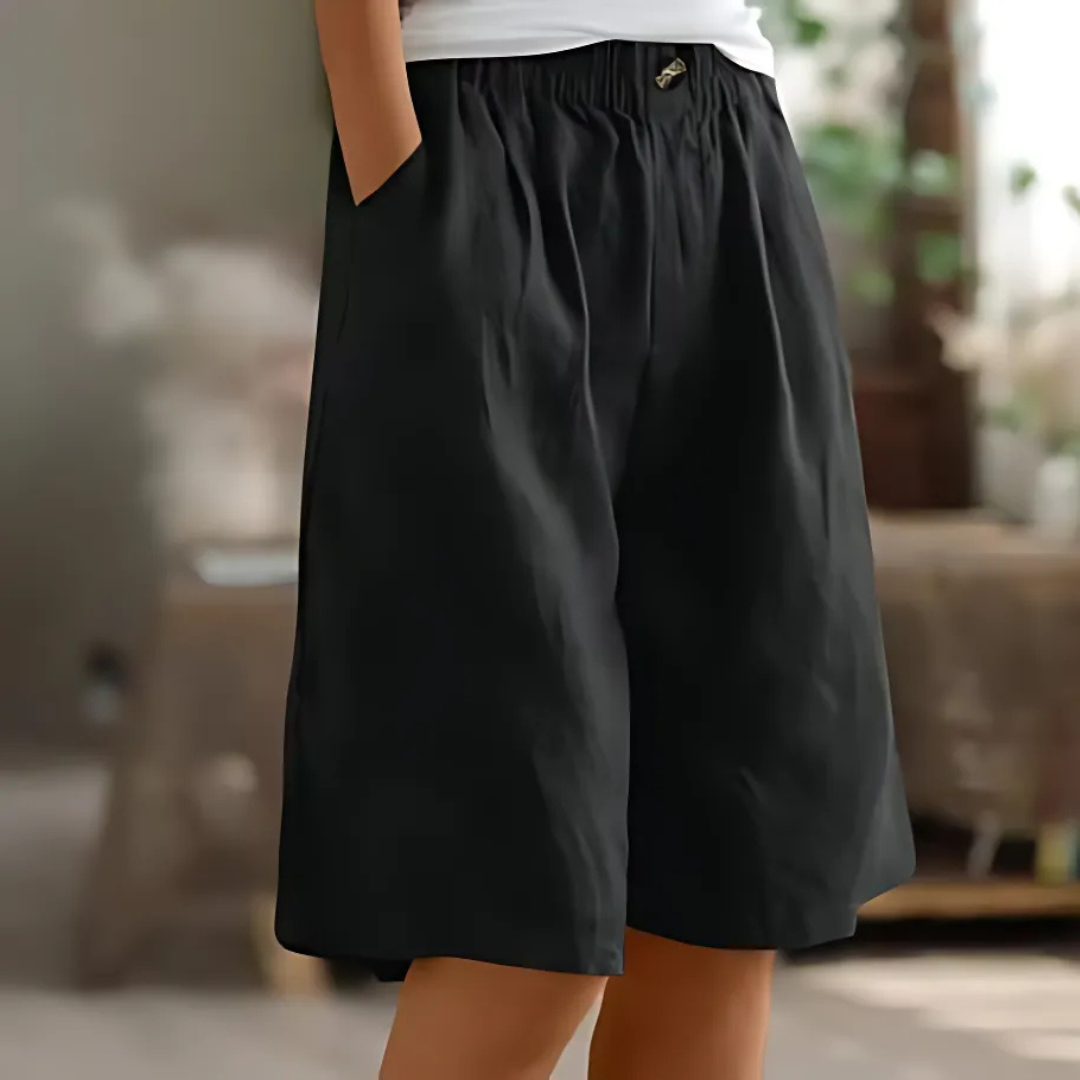 Maisie black elastic waist Bermuda shorts with pockets, offering breezy comfort and a polished casual silhouette.