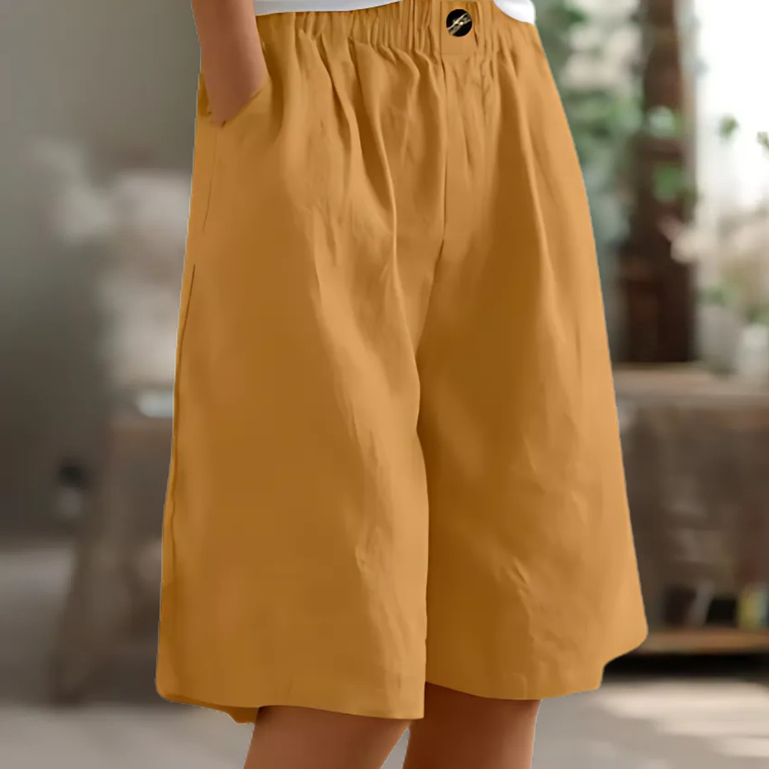 Maisie women's elastic waist Bermuda shorts in a versatile mustard yellow, featuring a relaxed fit and side pockets.