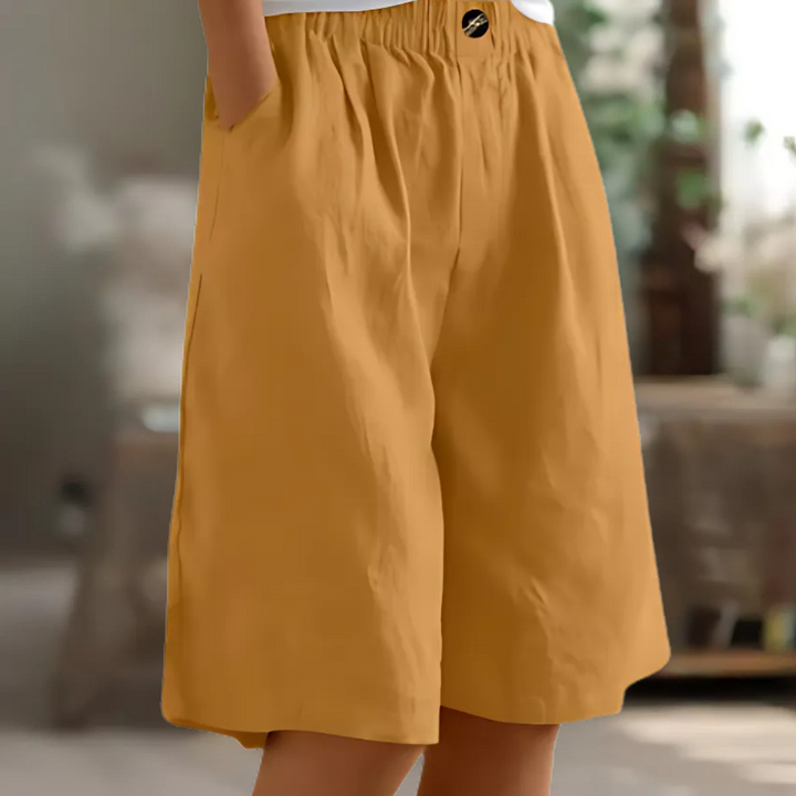Maisie women's elastic waist Bermuda shorts in a versatile mustard yellow, featuring a relaxed fit and side pockets.