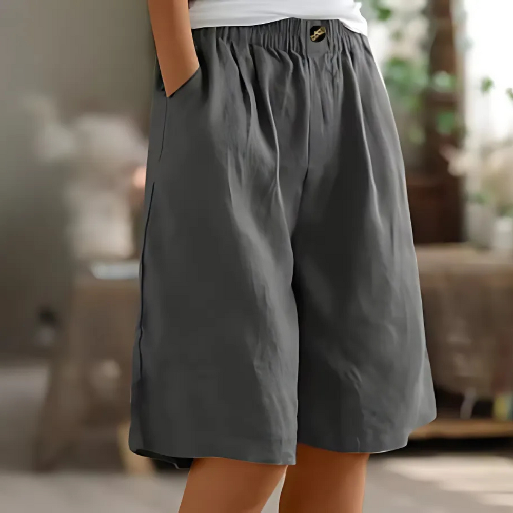 Maisie women's dark gray elastic waist Bermuda shorts with side pockets and a decorative button.