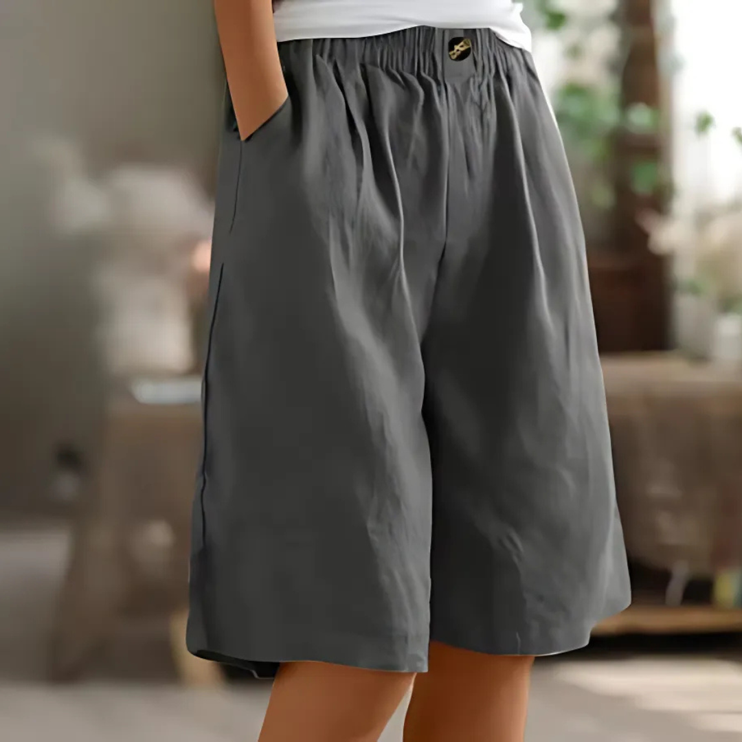 Maisie women's dark gray elastic waist Bermuda shorts with side pockets and a decorative button.