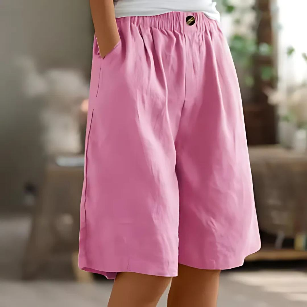 Maisie women's pink elastic waist Bermuda shorts with pockets and a single button detail.
