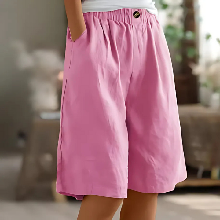 Maisie women's pink elastic waist Bermuda shorts with pockets and a single button detail.