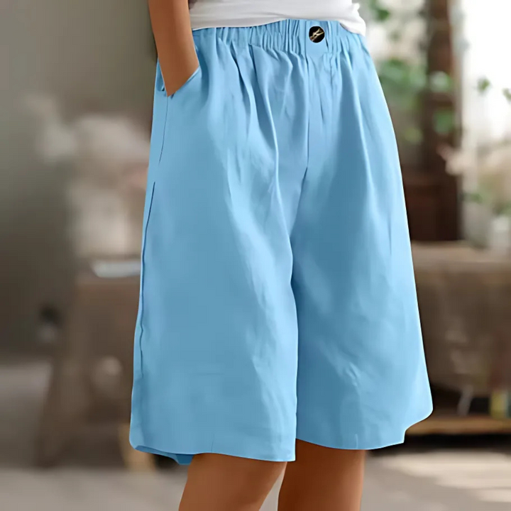 Maisie women's light blue elastic waist Bermuda shorts with pockets and a single button closure.