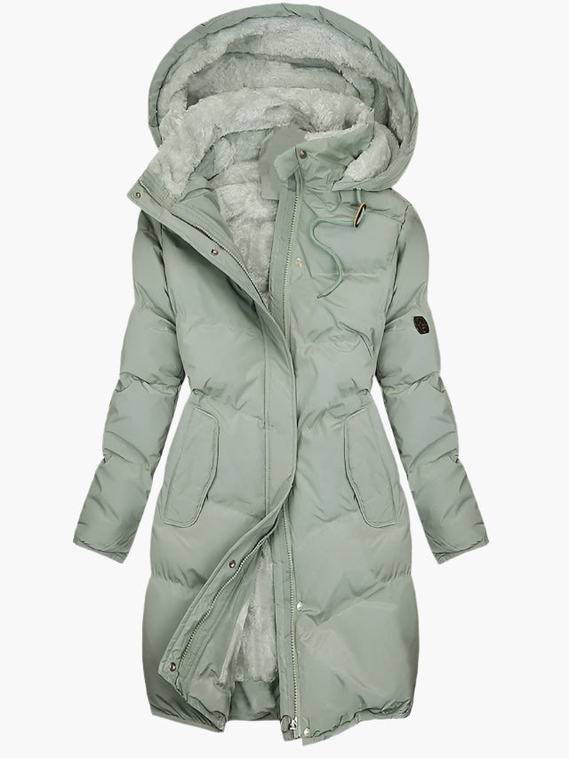 Sage green longline puffer coat with a plush-lined hood, front zip closure, and a flattering cinched waist design.