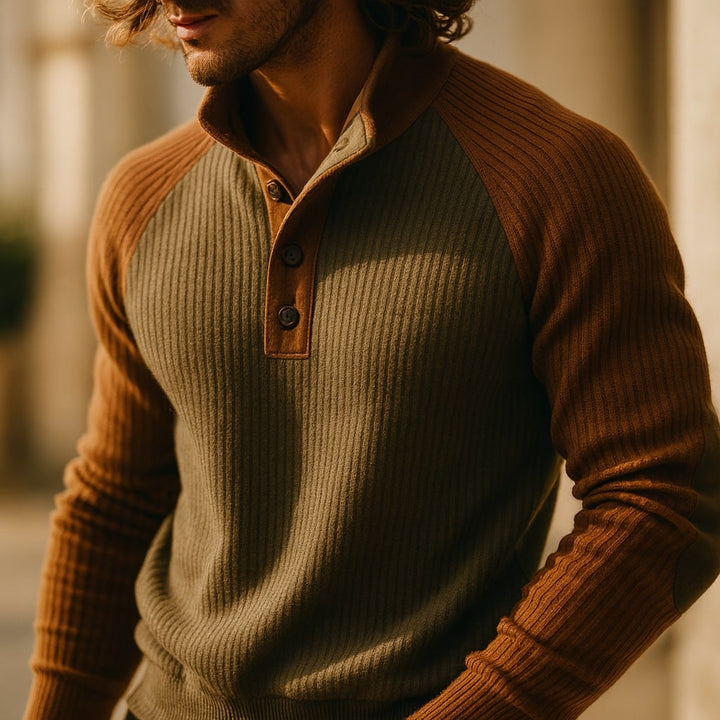 Olive green and brown ribbed knit jumper with a button-neck placket, raglan sleeves, and reinforced elbow patches.