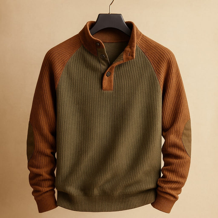 Olive green and brown ribbed knit jumper with a button-neck placket, raglan sleeves, and reinforced elbow patches.