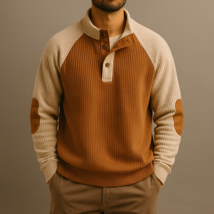 Men's ribbed knit jumper with a button-neck, contrast raglan sleeves, and brown elbow patches.