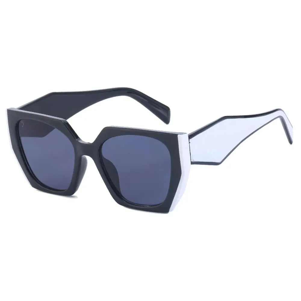 Margot women's oversized square sunglasses with bold black frames, white angular detailing, and dark gradient lenses.