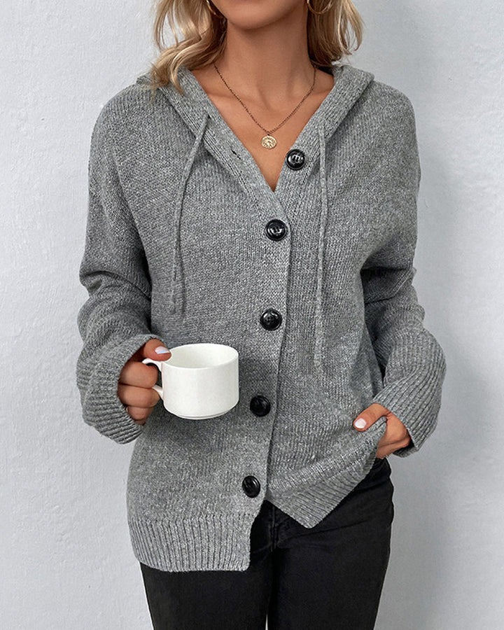 Grey hooded knit cardigan with a button-front closure, drawstring detail, and ribbed cuffs for a cozy, relaxed fit.