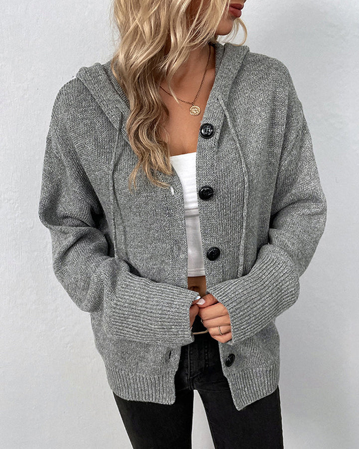 Grey hooded knit cardigan with a button-front closure, drawstring detail, and ribbed cuffs for a cozy, relaxed fit.