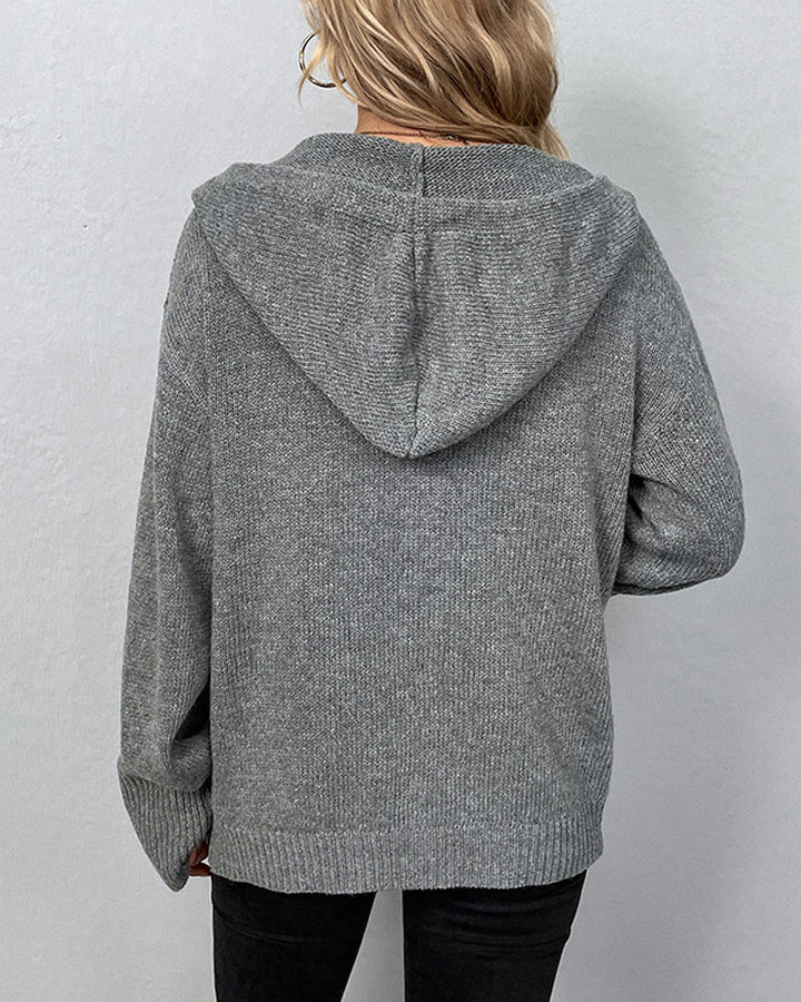 Back view of a cozy grey hooded knit cardigan with ribbed cuffs and a relaxed, comfortable fit.