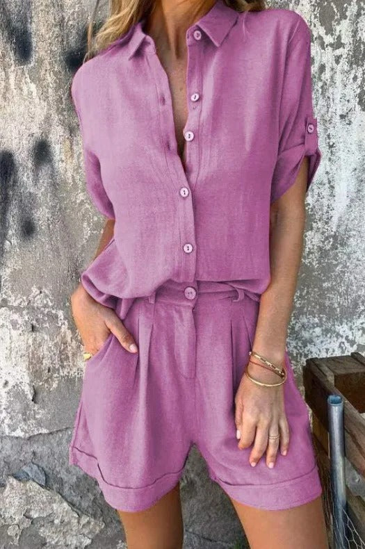 Woman wearing a mauve linen-blend set featuring a collared button-up shirt with roll-up sleeves and pleated shorts with pockets.