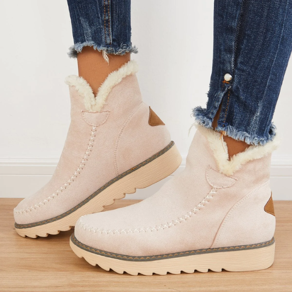 Marnie beige suede-look ankle boots with plush faux fur trim, moccasin stitching, and a grippy ribbed platform sole.