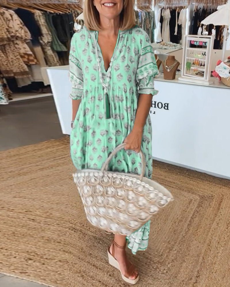 Matilda floral V-neck maxi dress in light fluid fabric, perfect for summer gatherings.