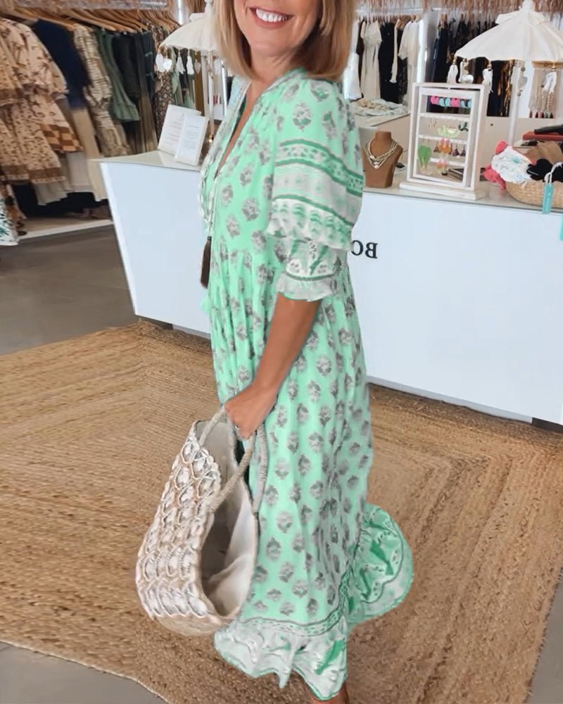 Matilda floral V-neck maxi dress in light, fluid fabric, featuring a graceful, body-skimming drape.