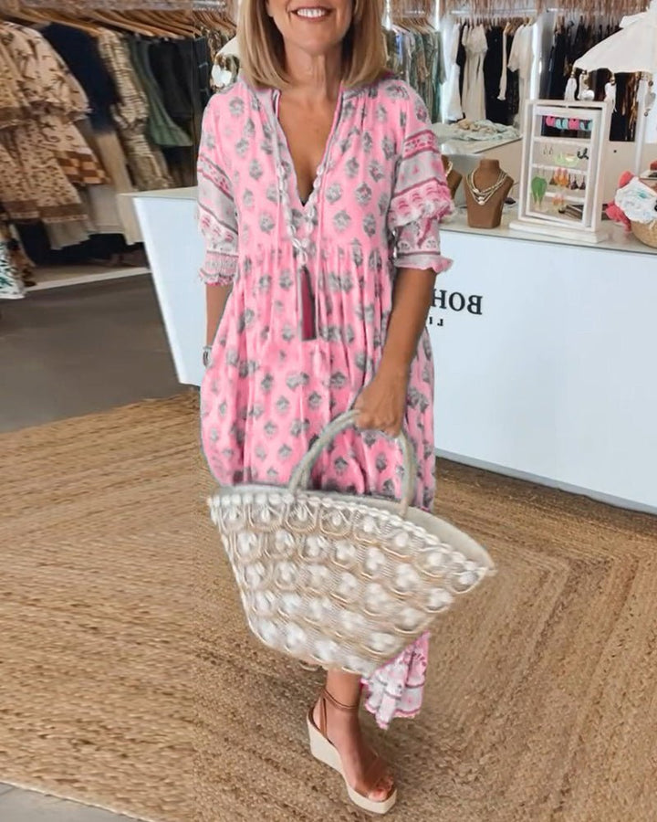 Matilda women's floral V-neck maxi dress in pink with a flattering V-neckline, soft waist, and fluid fabric.