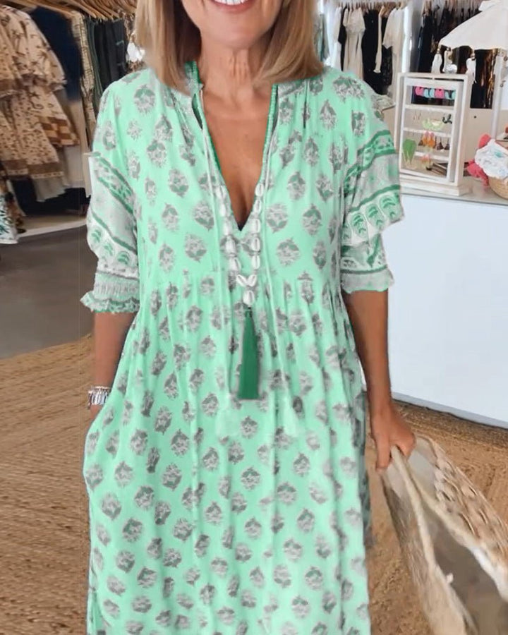 Matilda floral V-neck maxi dress in light, fluid fabric with a graceful, body-skimming drape.