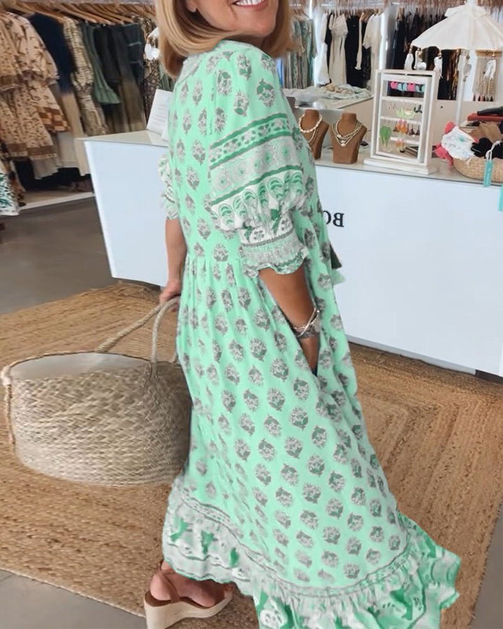 Matilda women's floral V-neck maxi dress in light green with a flattering, flowing silhouette.