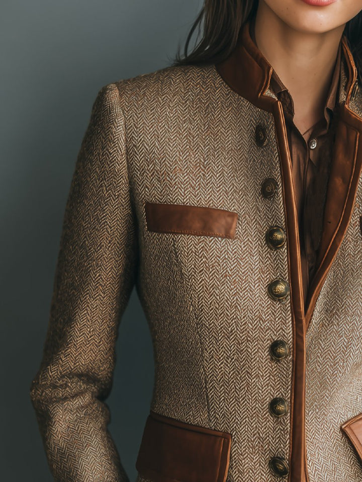 Women's brown herringbone tweed blazer with leather-look trim, band collar, and antique brass button front.