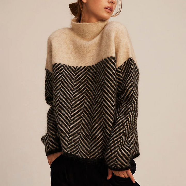 Oversized high-neck jumper in a soft, two-tone beige and black herringbone knit pattern with a relaxed fit.