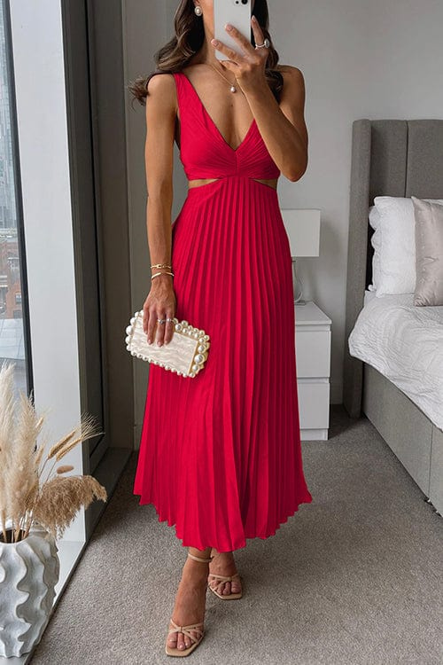 Red satin midi dress with a V-neck, waist cut-outs, and a pleated skirt, styled with strappy heels and a pearl clutch.