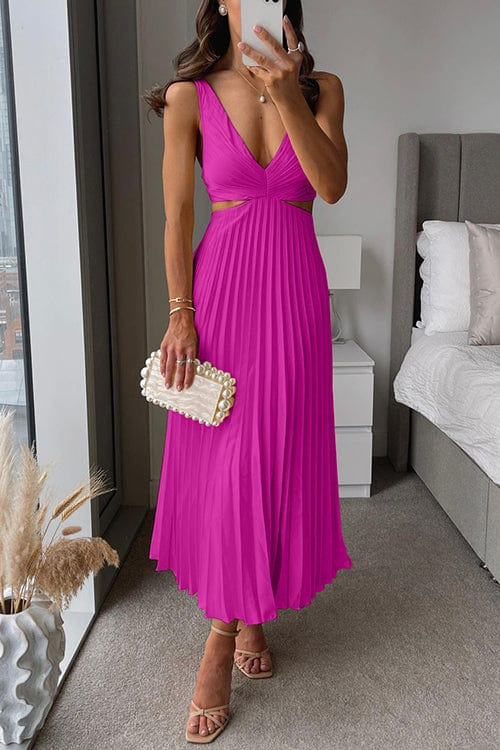 Magenta pleated satin midi dress with a V-neckline, waist cut-outs, and slim straps, styled with a pearl-embellished clutch.