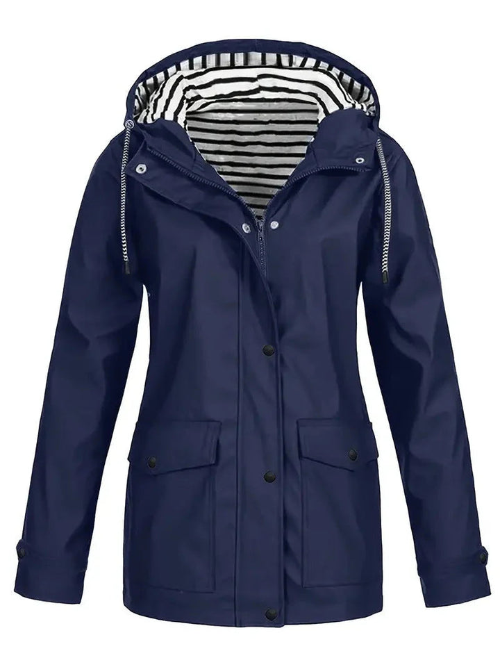Navy waterproof rain jacket featuring a drawstring hood, snap-down storm flap, and a stylish black and white striped lining.