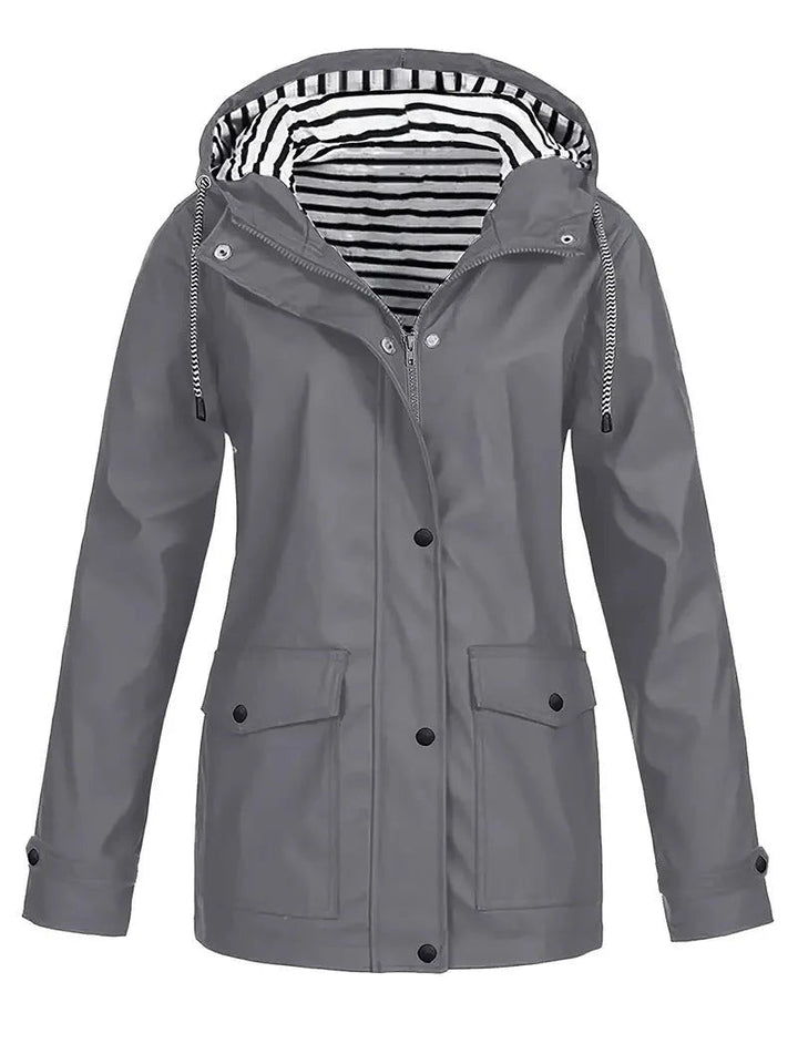 Grey waterproof rain jacket featuring a drawstring hood, snap-down storm flap, and a stylish black and white striped lining.