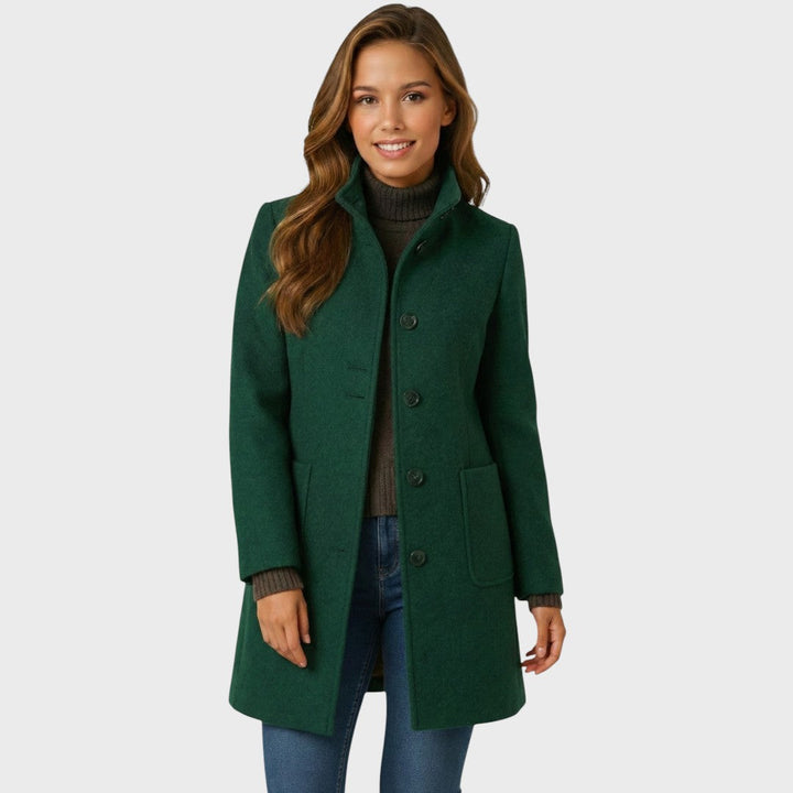 Tailored forest green single-breasted coat with a smart stand collar, button-up front, and practical patch pockets.