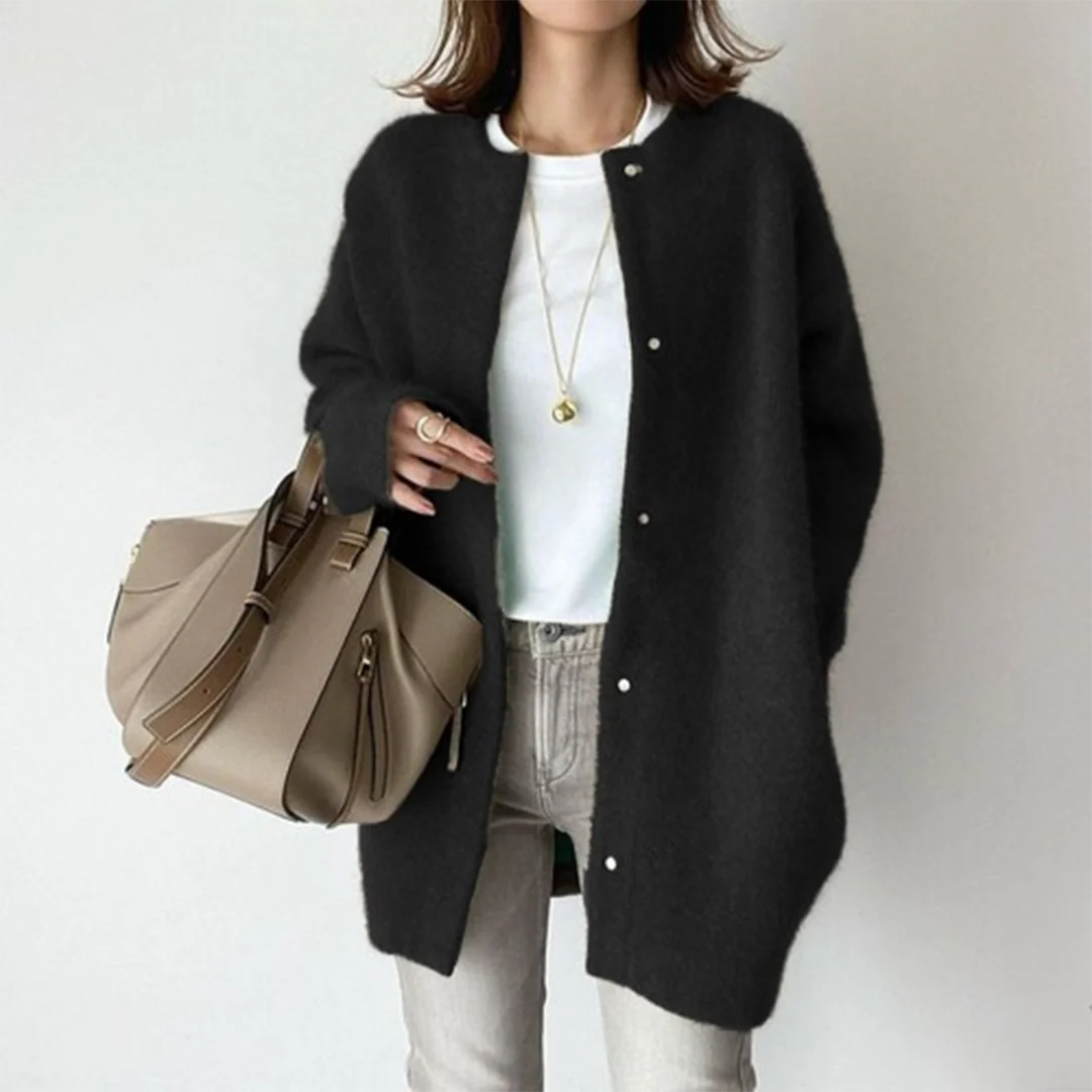 Black oversized knit cardigan with a round neckline and button-up front, styled for a relaxed, cozy layered look.