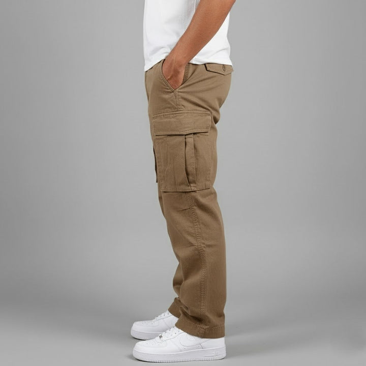 Side profile of men's relaxed-fit khaki cotton cargo trousers with side pockets, worn with a white t-shirt and sneakers.